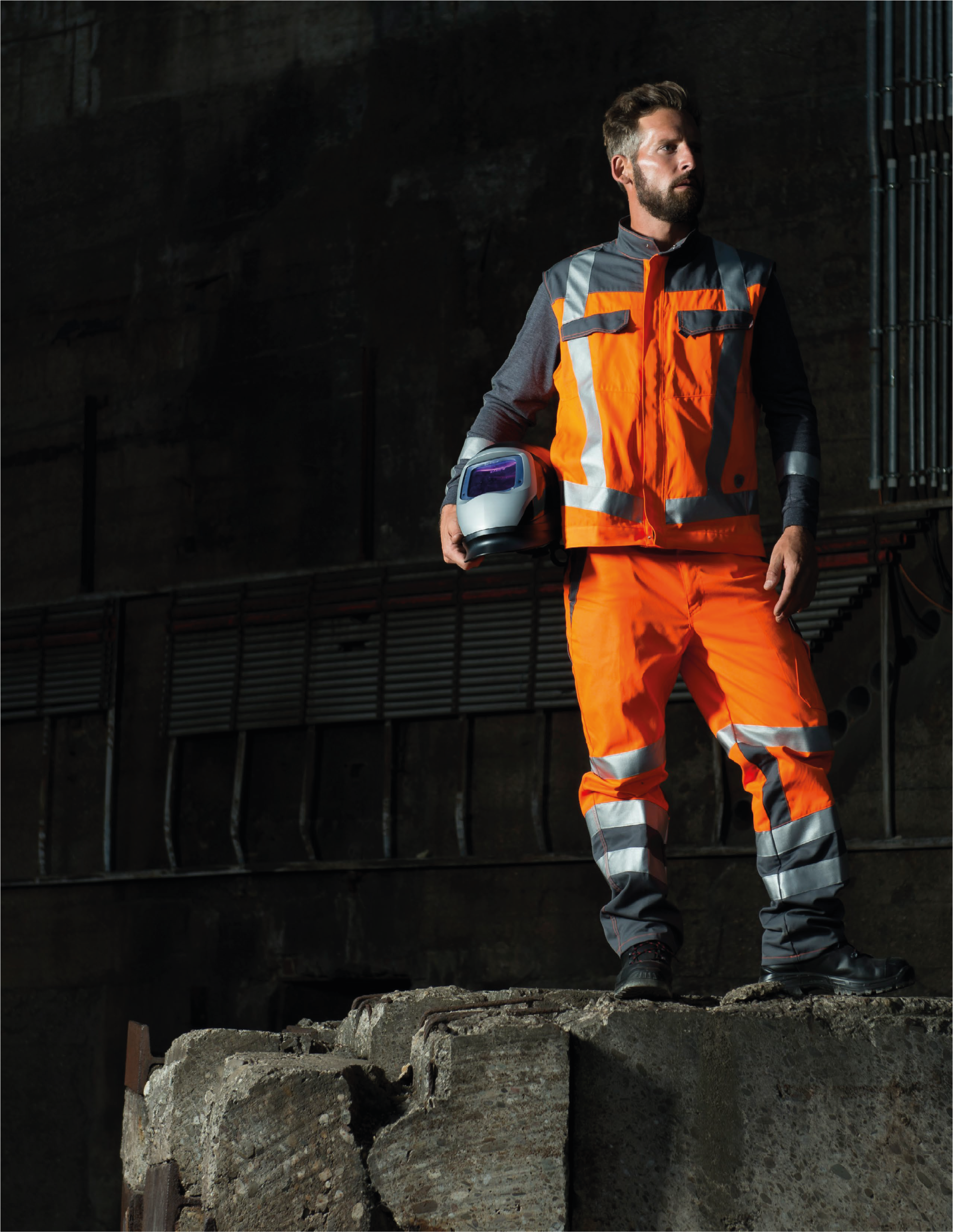 Worker wearing 3M Scotchlite reflective material for enhanced visibility